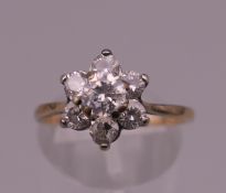 A 9 ct gold flowerhead ring. Ring size P. 2.2 grammes total weight.