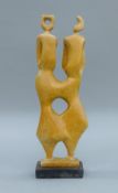 An Italian carved wooden sculpture, in the manner of Henry Moore. 43 cm high.