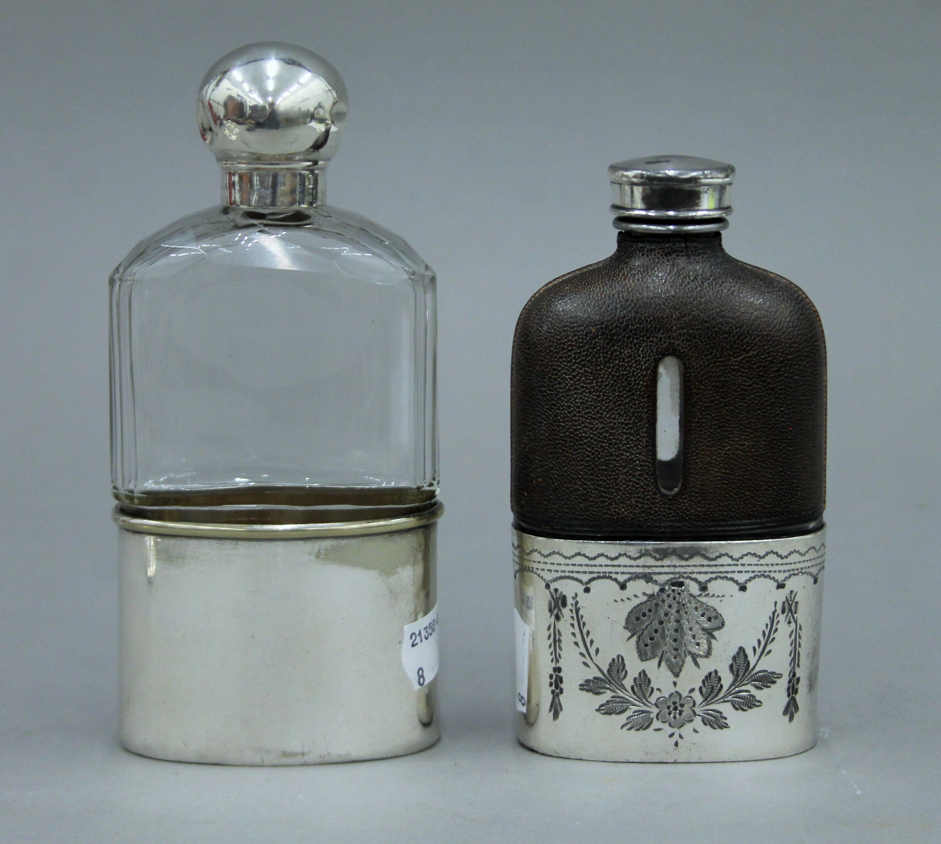 A silver topped cut glass spirit flask,