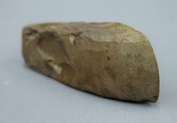 A stone axe head. 14 cm long.