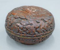 A Chinese cinnabar round lidded box. 11 cm diameter.