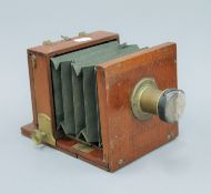 A mahogany plate camera with brass lens. 23 cm long.