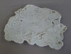 A celadon brush washer centred with a crab. 19 cm wide.