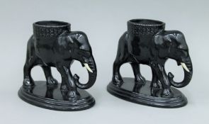 A pair of early 20th century vases formed as elephants. 17 cm high.