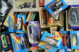 A collection of boxed die cast vehicles.