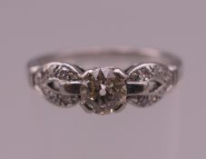 A vintage platinum and diamond ring, the central stone spreading to approximately 0.