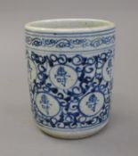 A Chinese pottery blue and white brush pot. 12 cm high.