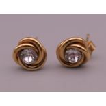 A pair of 9 ct gold earrings. 7 mm wide. 0.7 grammes total weight.