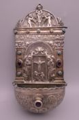 A Continental cabochon mounted silver wall font. 19 cm high. 134.8 grammes total weight.