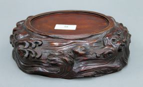 A 19th century Chinese carved wooden stand. 22 cm wide.