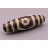 A gold inlaid agate dzi bead. 3.5 cm long.