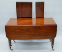 An early 19th century mahogany drop flap pull-out extending dining table, in the manner of Gillows,