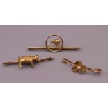 Three 9 ct gold bar brooches, one centred with a pig. The largest 5 cm long. 13.