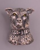 A silver dog form brooch.