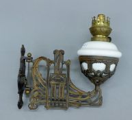 A Victorian wall mounted oil lamp.