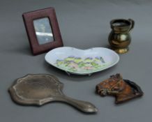 A silver hand mirror, a brass tankard, etc.