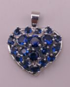 A silver heart formed pendant. 3 cm high.