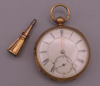An 18 ct gold open faced pocket watch and key. 4.5 cm diameter. The watch 91.1 grammes total weight.
