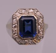 An unmarked gold sapphire and diamond ring. Ring size N/O. 3.2 grammes total weight.