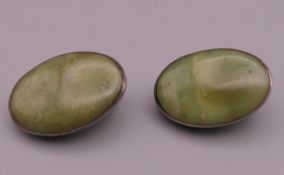 A pair of silver and jade ear clips. 2 cm high.