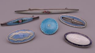 Six silver and enamel brooches. The largest 7.75 cm long.