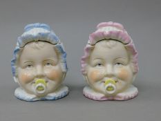 A pair of porcelain baby head jars. 12 cm high.