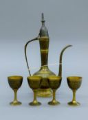 A Turkish brass coffee set. The coffee pot 28 cm high.