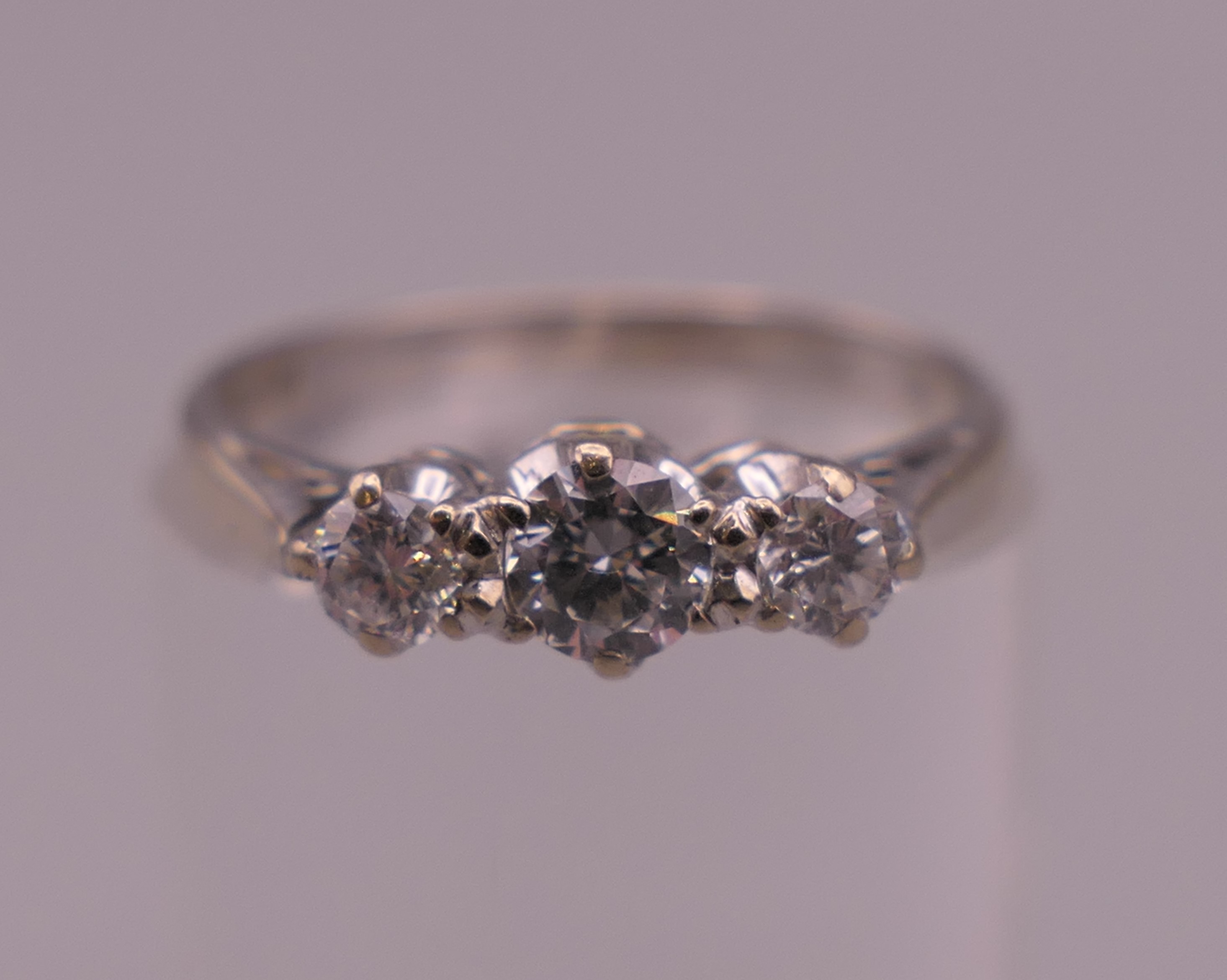 An 18 ct white gold three stone diamond ring. Ring size K/L. 2.5 grammes total weight. - Image 4 of 6