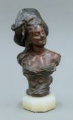 A signed French Art Nouveau patinated bronze female bust, mounted on an onyx plinth base.