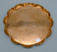 An Arts and Crafts copper tray depicting a galleon. 28 cm diameter.