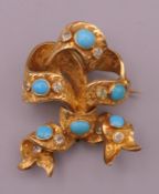 A Victorian unmarked 18 ct gold turquoise set ribbon form brooch. 4.5 cm high. 10.