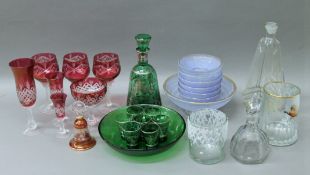 A quantity of various glassware, including a green decorated decanter and glasses, cranberry glass,