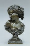 A 19th century bronze bust of a young maiden with grape and vine leaf adornments. 22.5 cm high.