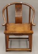 A 19th century Chinese carved elm open armchair. 64 cm wide.