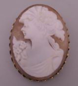 A 9 ct gold mounted cameo brooch. 5 cm high.