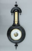 A Victorian ebonised aneroid barometer. 45 cm high.
