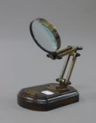 A magnifier on stand. 9 cm wide.