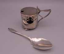 A silver jam spoon and an Art Nouveau silver mustard pot. The latter 6.5 cm high.