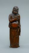 An 18th century Chinese bamboo carving of Buddha holding a toad. 19 cm high.
