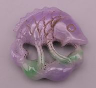 A lilac jade fish carving. 5.5 cm high.