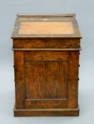 A 19th century walnut Davenport with sliding top. 59 cm wide.