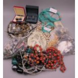 A quantity of costume jewellery and wristwatches.