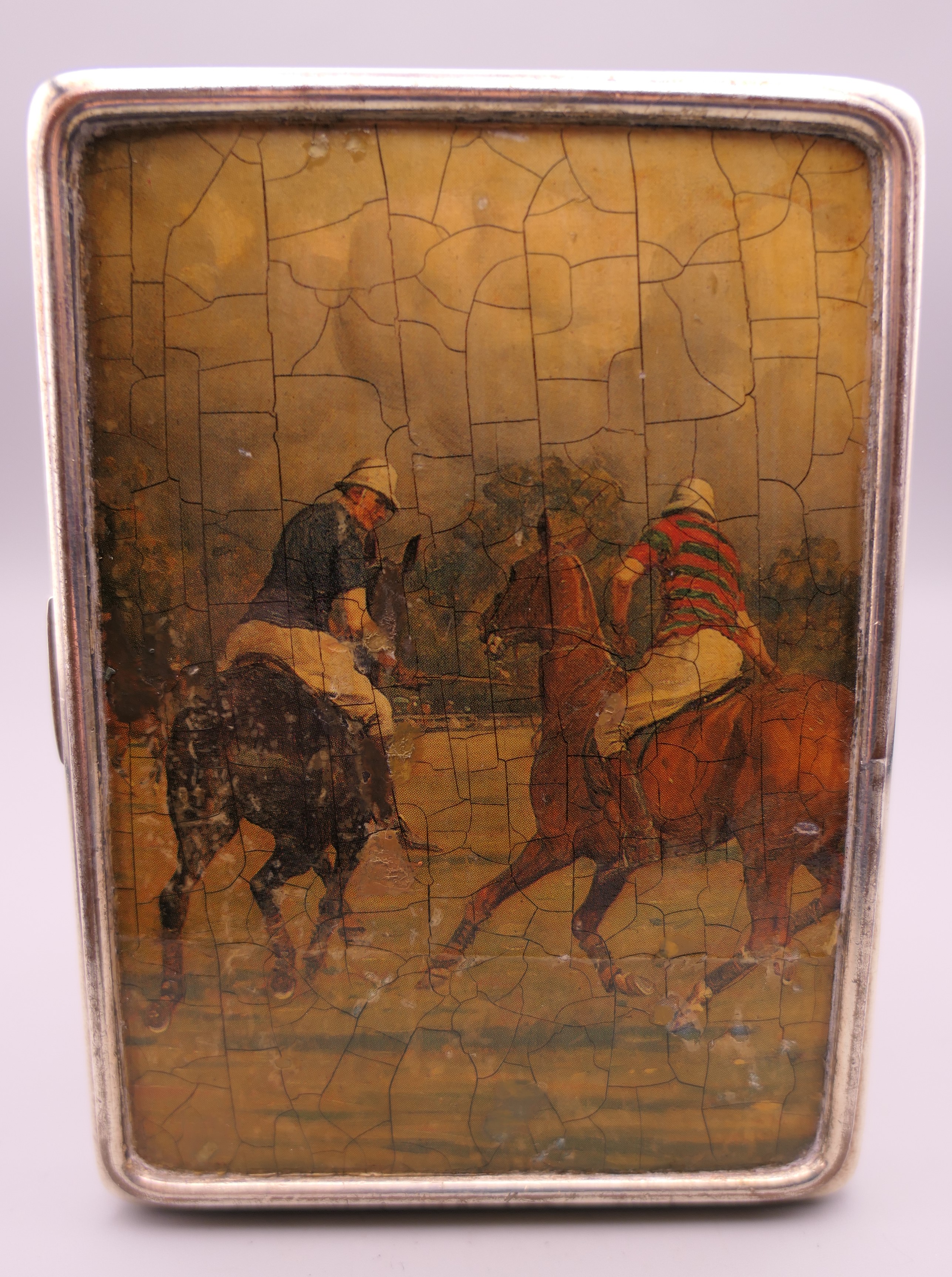 A silver cigarette case decorated with polo scenes. 8.5 cm wide. 219.2 grammes total weight. - Image 2 of 10