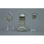 Three small scent bottles, each with silver mounts. The largest 6.5 cm high.
