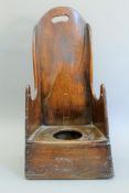 A 19th century elm child's chair. 33 cm wide.