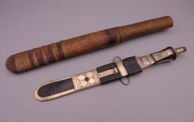 A North African leather and white metal finely tooled dagger and an Asian dagger with cane binding.