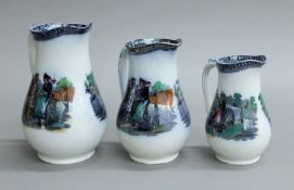 A set of three 19th century graduated Prattware type jugs, depicting cyclists in scenic landscapes.