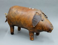 A Liberty type leather pig foot stool. 70 cm long.