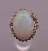 An unmarked gold opal and diamond ring. Ring size Q. 6.8 grammes total weight.