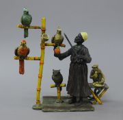 A cold painted bronze model of a parrot seller. 17 cm high.
